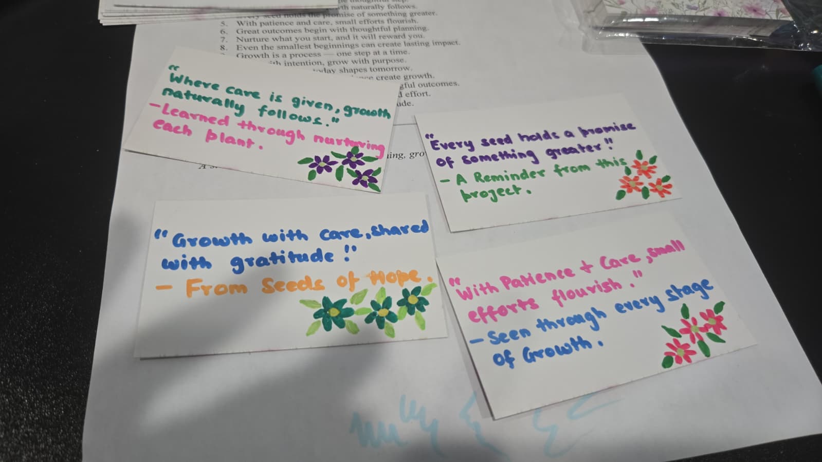 Hand-lettered thank you note cards with growth quotes and flower illustrations tucked into gift baskets